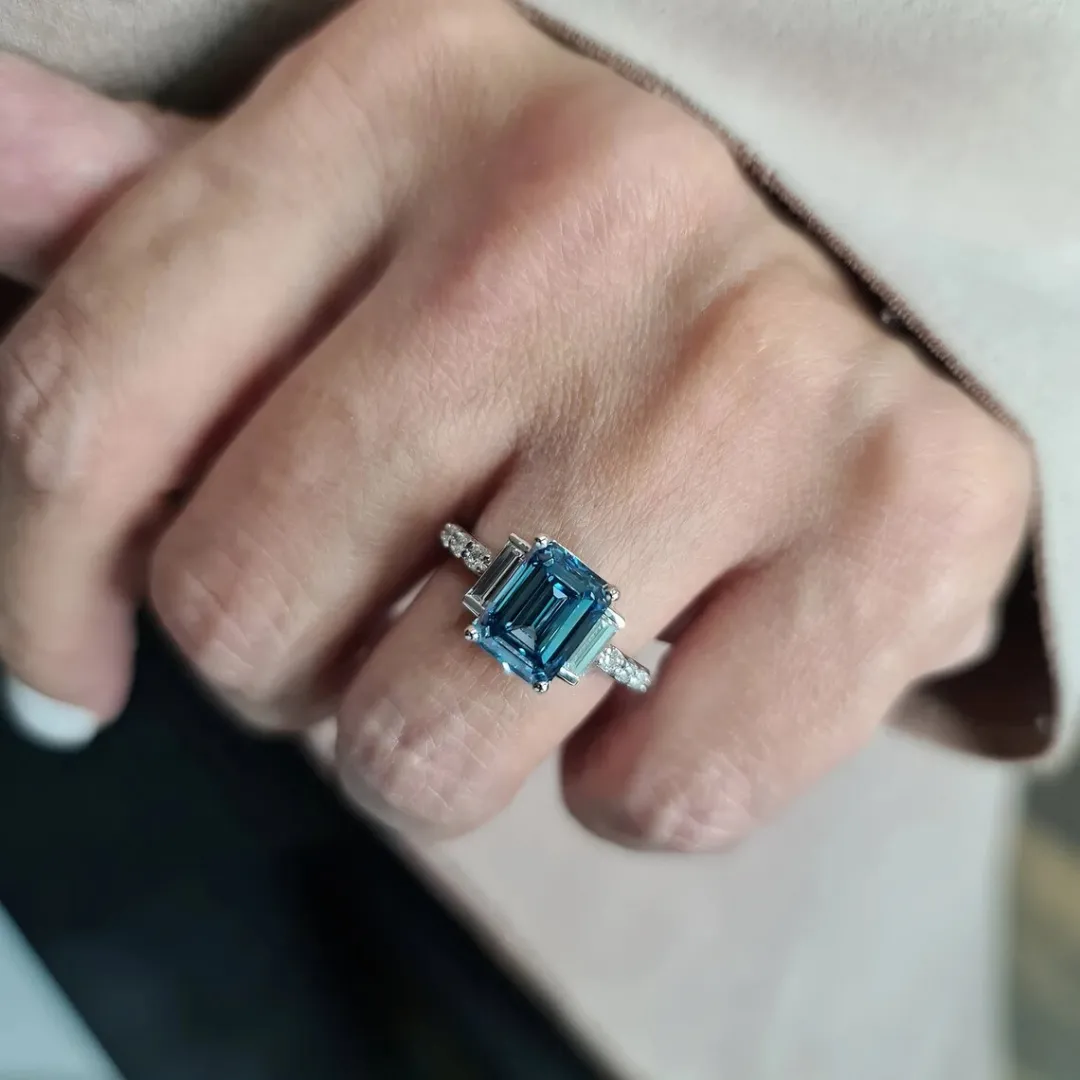 /public/photos/live/Blue Emerald Cut Moissanite Three Stone Engagement Ring 610 (5).webp